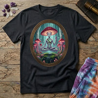A mushroom-capped alien meditating on a mossy rock in an oval forest frame, on a Black unisex t-shirt