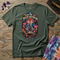 Take Me to Your Shaman lettering above a neon amanita-crowned figure meditating in a glowing forest, on a Military Green unisex t-shirt