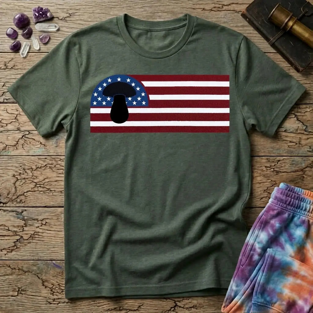 A black mushroom silhouette over an American flag of stars and stripes, on a Military Green unisex t-shirt