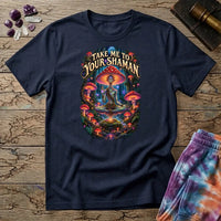 Take Me to Your Shaman lettering above a neon amanita-crowned figure meditating in a glowing forest, on a Navy unisex t-shirt