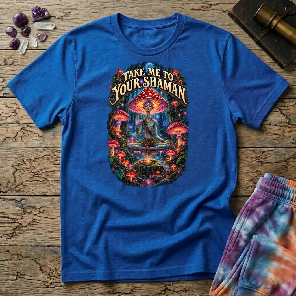 Take Me to Your Shaman lettering above a neon amanita-crowned figure meditating in a glowing forest, on a Royal blue unisex t-shirt