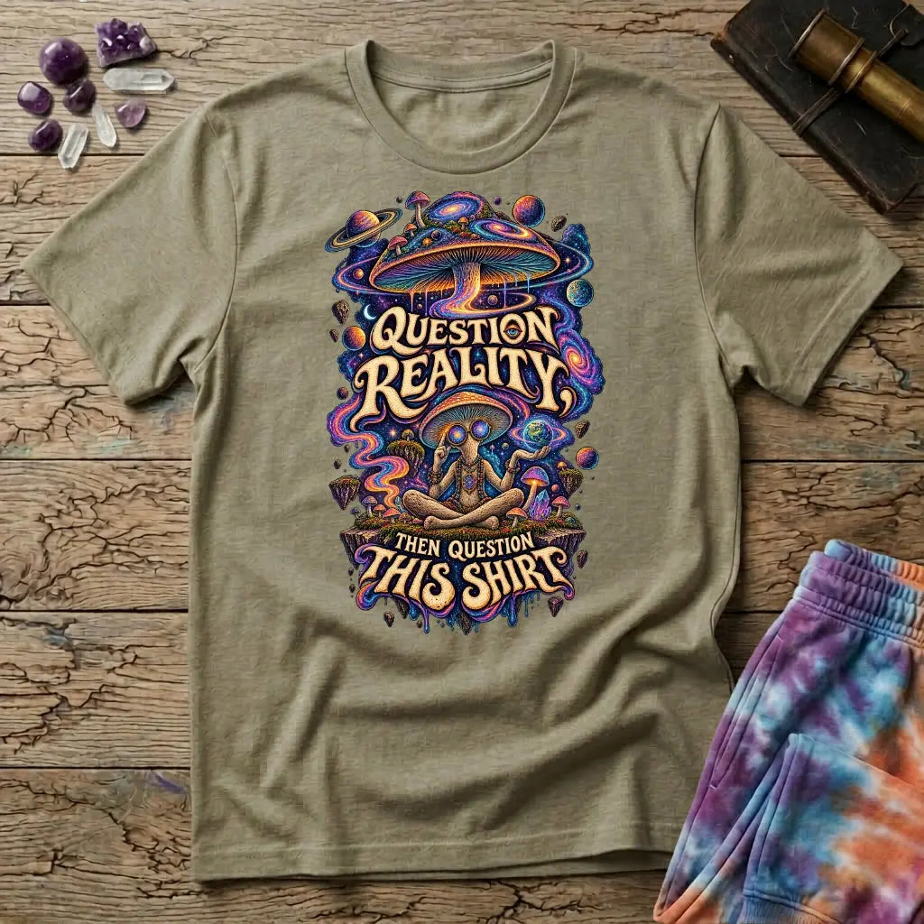 Question Reality, Then Question This Shirt lettering around a cosmic mushroom and a meditating figure, on a Sand unisex t-shirt