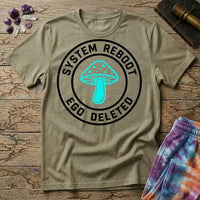 System Reboot Ego Deleted circular badge with a turquoise mushroom at its center, on a Sand unisex t-shirt