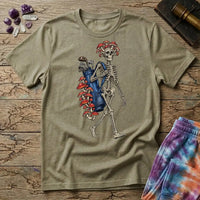 Skeleton carrying a navy golf bag with red amanita mushrooms sprouting from the clubs and skull, on a Sand unisex t-shirt