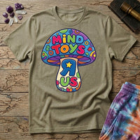 Mind Toys R Us mushroom, a rainbow-capped toadstool lettered Mind Toys with a backwards R and gold star on the stem, on a Sand unisex t-shirt