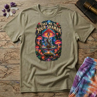 Take Me to Your Shaman lettering above a neon amanita-crowned figure meditating in a glowing forest, on a Sand unisex t-shirt