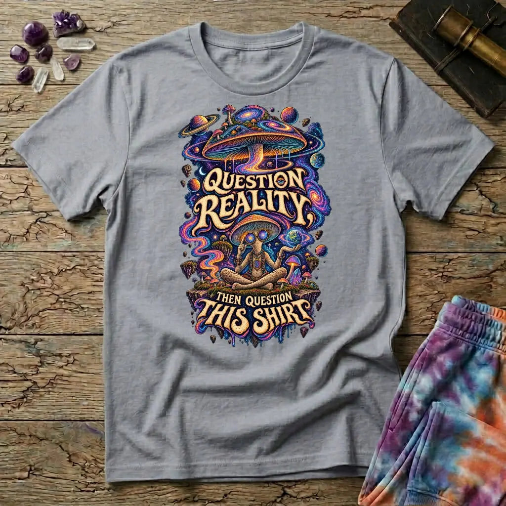 Question Reality, Then Question This Shirt lettering around a cosmic mushroom and a meditating figure, on a Sport Grey unisex t-shirt