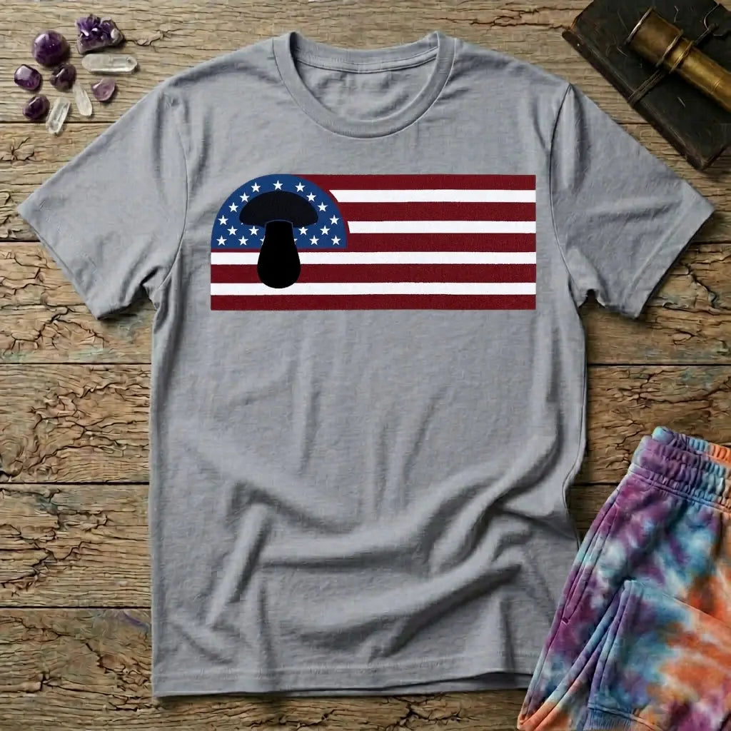 A black mushroom silhouette over an American flag of stars and stripes, on a Sport Grey unisex t-shirt