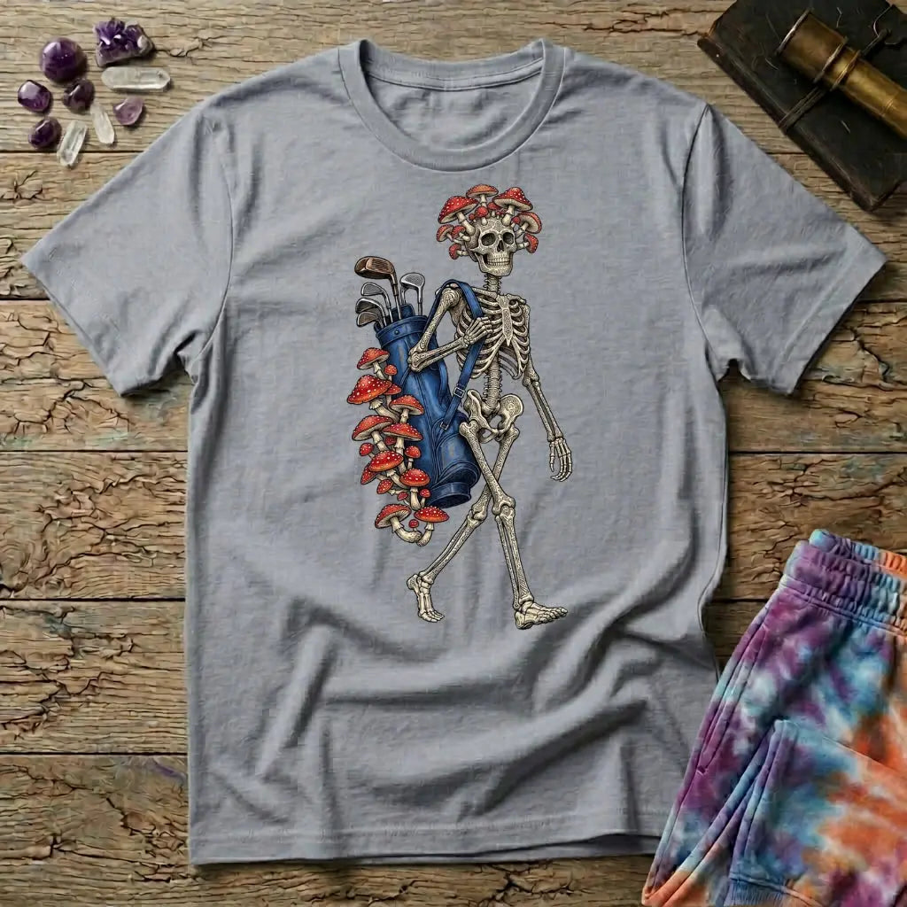Skeleton carrying a navy golf bag with red amanita mushrooms sprouting from the clubs and skull, on a Sport Grey unisex t-shirt