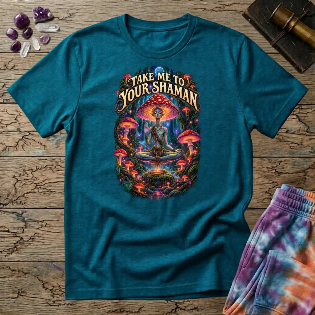 Take Me to Your Shaman lettering above a neon amanita-crowned figure meditating in a glowing forest, on a Tropical Blue unisex t-shirt