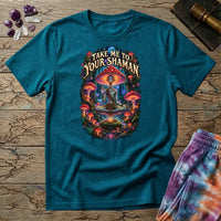 Take Me to Your Shaman lettering above a neon amanita-crowned figure meditating in a glowing forest, on a Tropical Blue unisex t-shirt