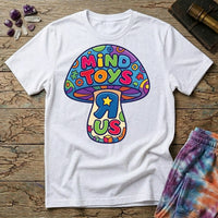Mind Toys R Us mushroom, a rainbow-capped toadstool lettered Mind Toys with a backwards R and gold star on the stem, on a White unisex t-shirt