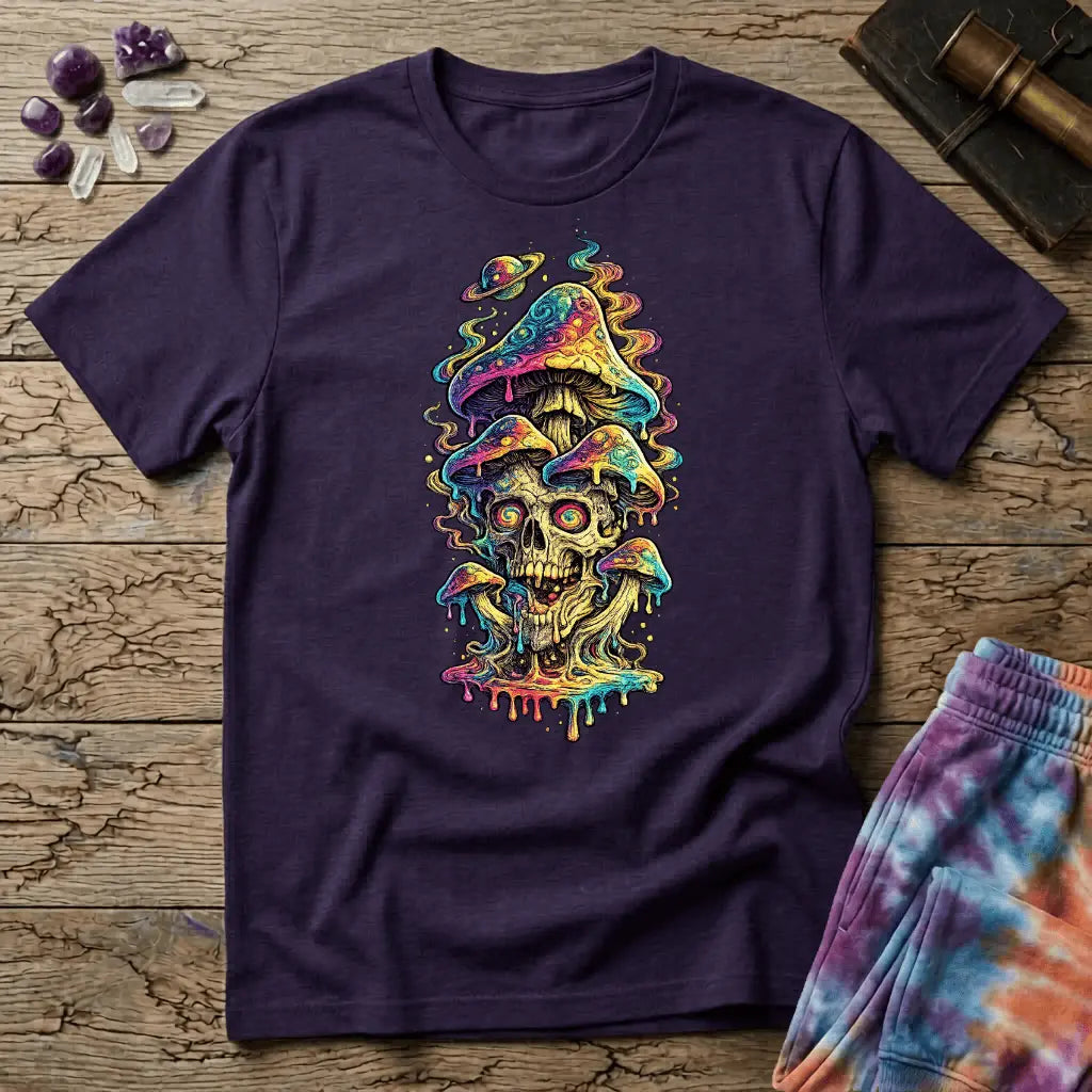 Grinning skull with hypnotic swirling eyes beneath a stack of dripping rainbow mushrooms and a small Saturn, on a unisex t-shirt