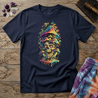 Grinning skull with hypnotic swirling eyes beneath a stack of dripping rainbow mushrooms and a small Saturn, on a unisex t-shirt