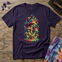 Cluster of neon mushrooms dripping color into a glowing puddle with rainbow tendrils and a floating planet, on a unisex t-shirt