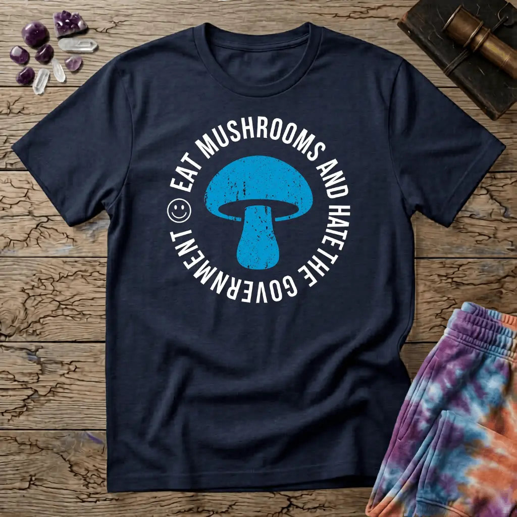 Distressed blue mushroom badge ringed by circle text and a small smiley face, on a unisex t-shirt