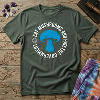 Distressed blue mushroom badge ringed by circle text and a small smiley face, on a unisex t-shirt