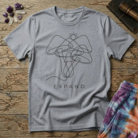 Single unbroken line tracing a rising sun into a cluster of mushroom caps and stems, minimalist line art, on a unisex t-shirt