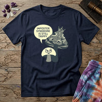 Small worried mushroom beside a larger crowned one, captioned imposter syndrome is still trippy, on a unisex t-shirt
