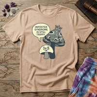 Small worried mushroom beside a larger crowned one, captioned imposter syndrome is still trippy, on a unisex t-shirt