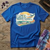 Retro airline-style badge with a plane soaring past a golden sunburst and rainbow streaks, reading LSD Travel Agency, on a unisex t-shirt