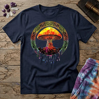Watercolor mushroom in fiery reds and oranges framed by an ornate Celtic knotwork ring with roots trailing below, on a unisex t-shirt