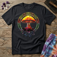 Watercolor mushroom in fiery reds and oranges framed by an ornate Celtic knotwork ring with roots trailing below, on a unisex t-shirt